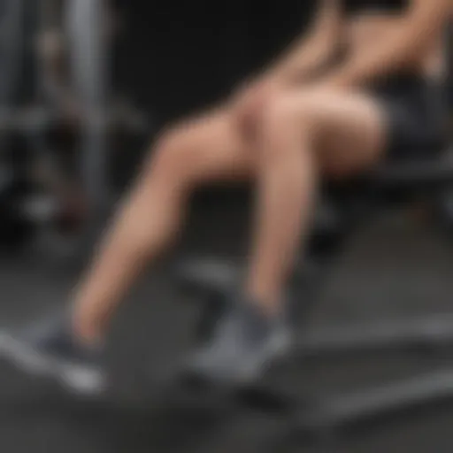 Individual performing seated leg extensions to strengthen quads