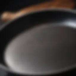 Close-up of a gleaming cast iron frying pan showing the seasoned surface